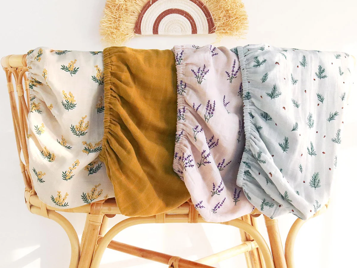Printed muslin nursery blankets in coordinated colors and botanical patterns
