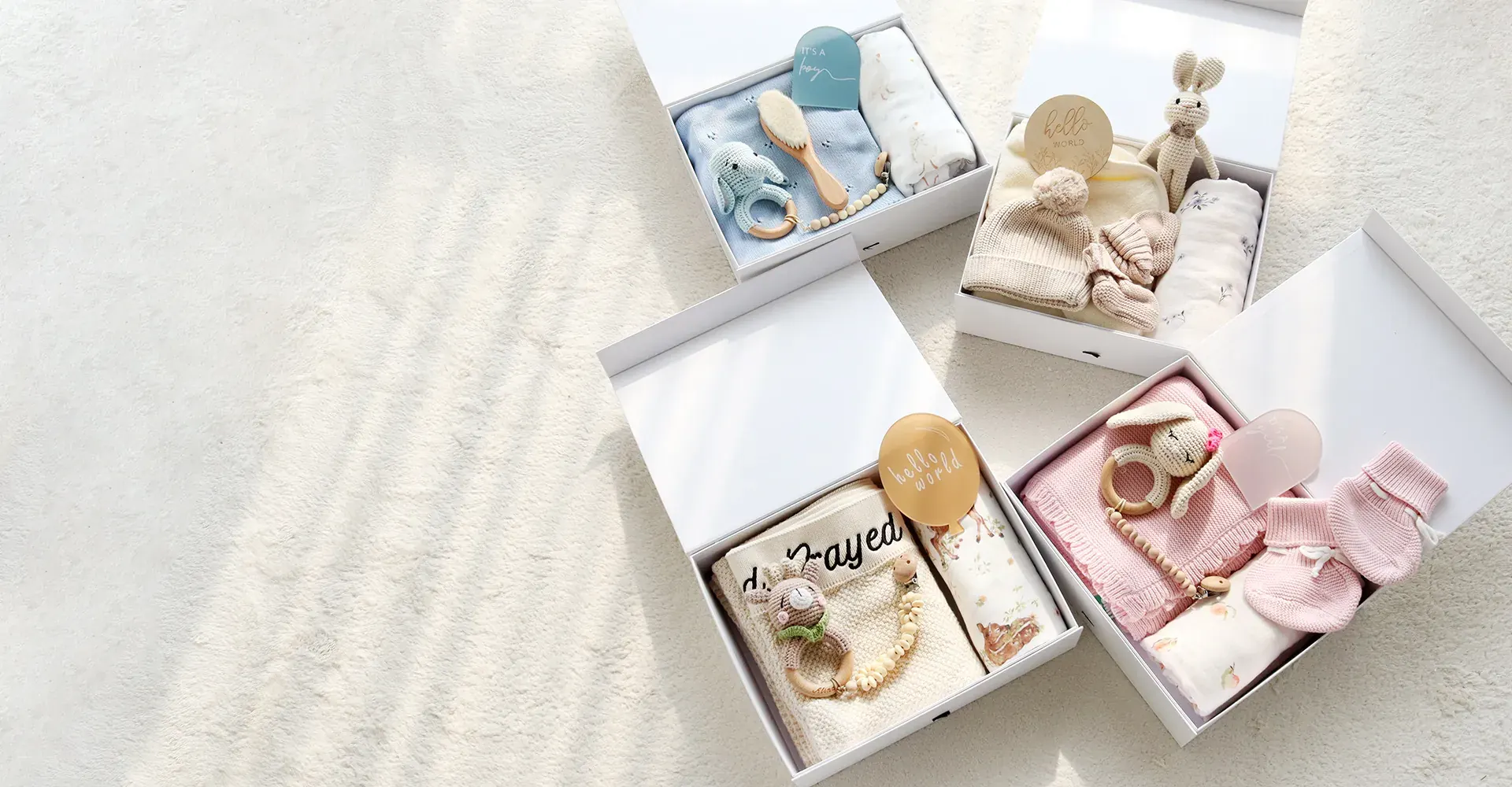 Private label baby products arranged with clothing blankets and crochet toys