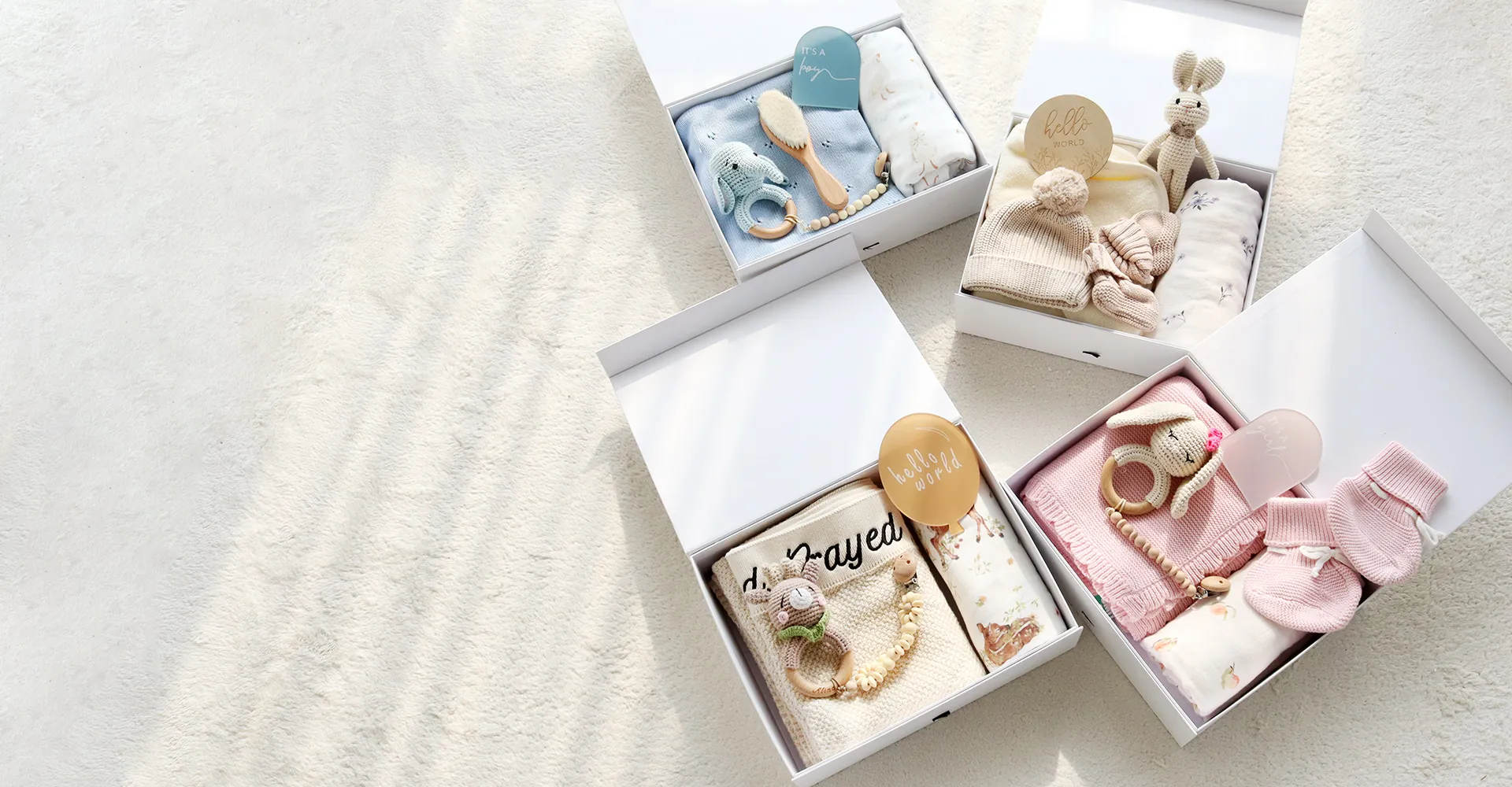 Private label baby products arranged with clothing blankets and crochet toys