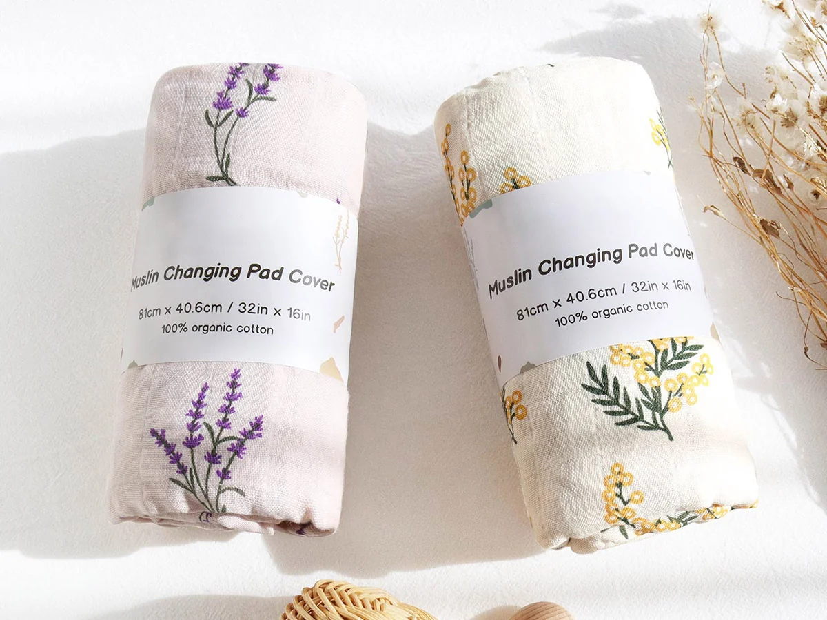 Retail packaged muslin changing pad covers with botanical prints